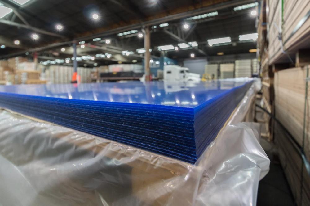 A stack of acrylic sheets under protective film